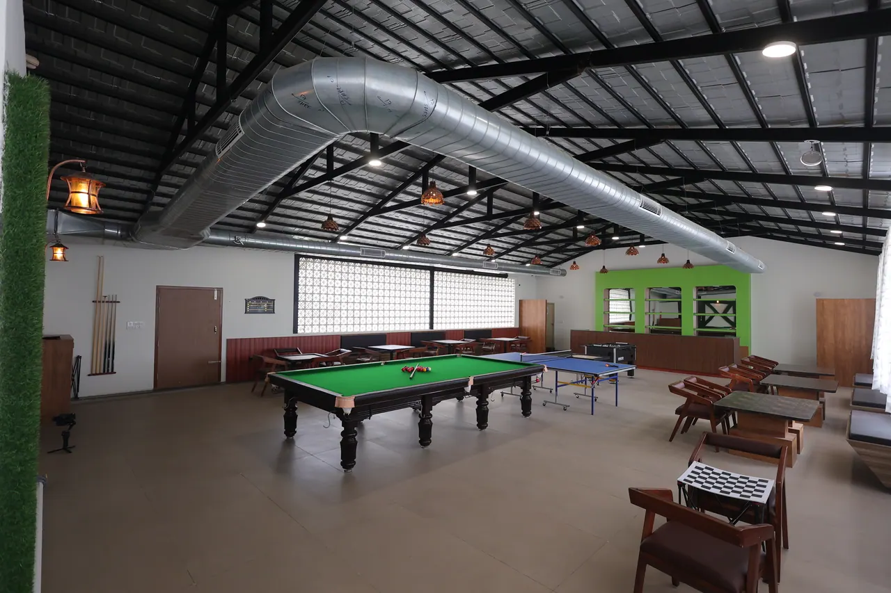 The indoor games hall at Sree Raaga Resorts with a snooker table and table tennis
