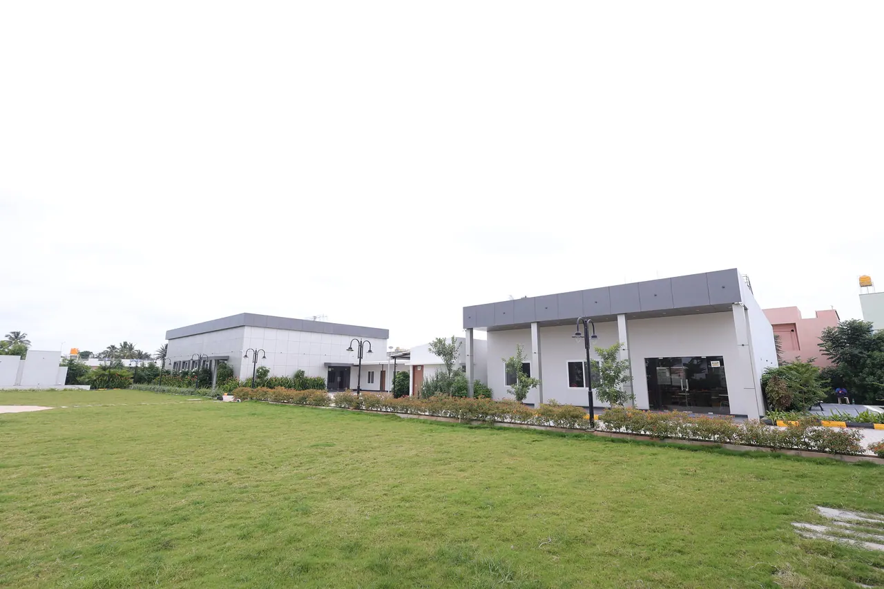 The event lawn at Sree Raaga Resorts set with banquet tables and seating in daylight