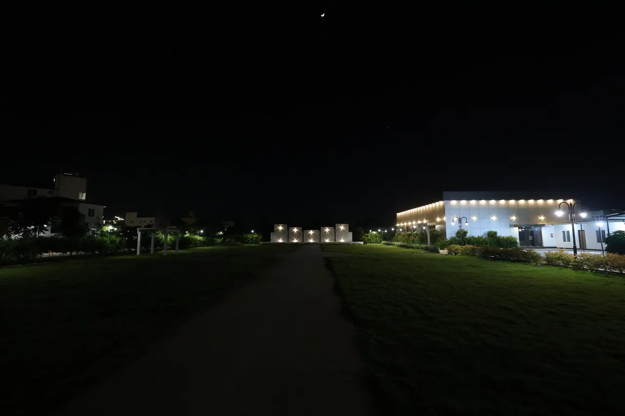 The event lawn at Sree Raaga Resorts at night, set with banquet tables and lit for dinner