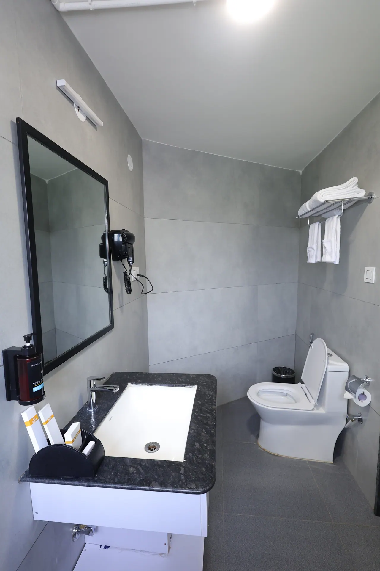 Tiled guest bathroom showing the walk-in shower area and WC