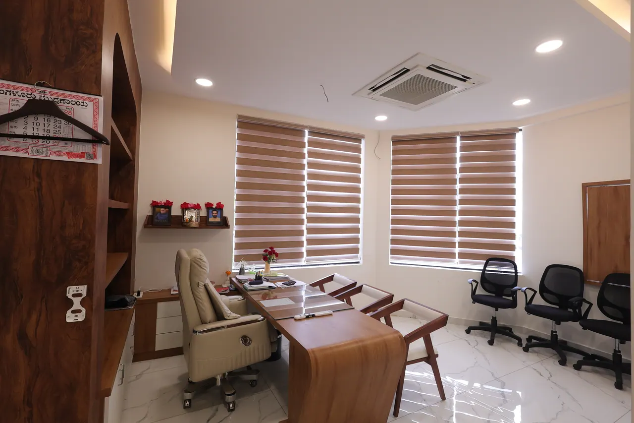 The board room at Sree Raaga Resorts with a meeting table, seating and a wall-mounted screen