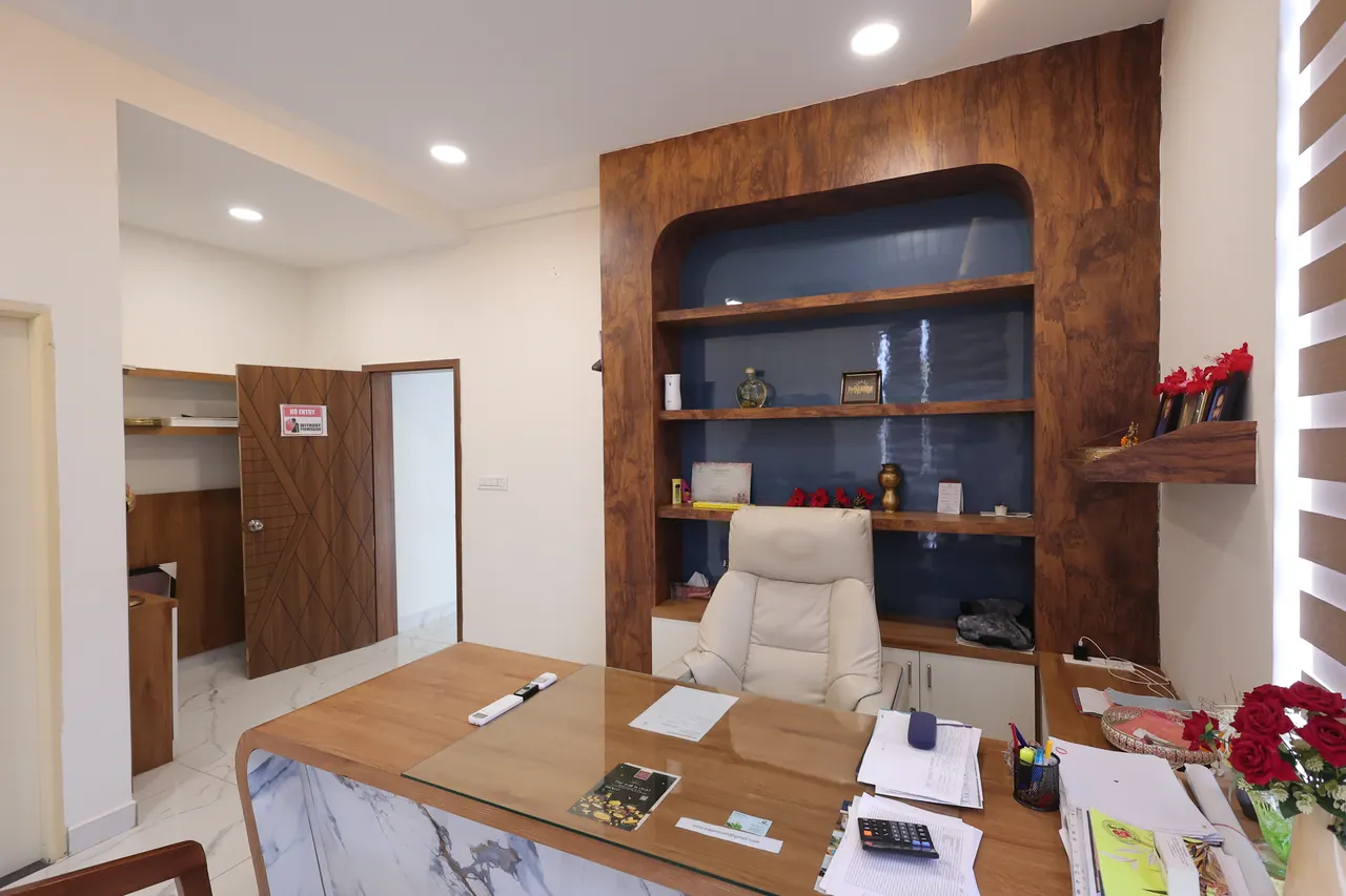 A private meeting room at Sree Raaga Resorts with a table, seating and a screen