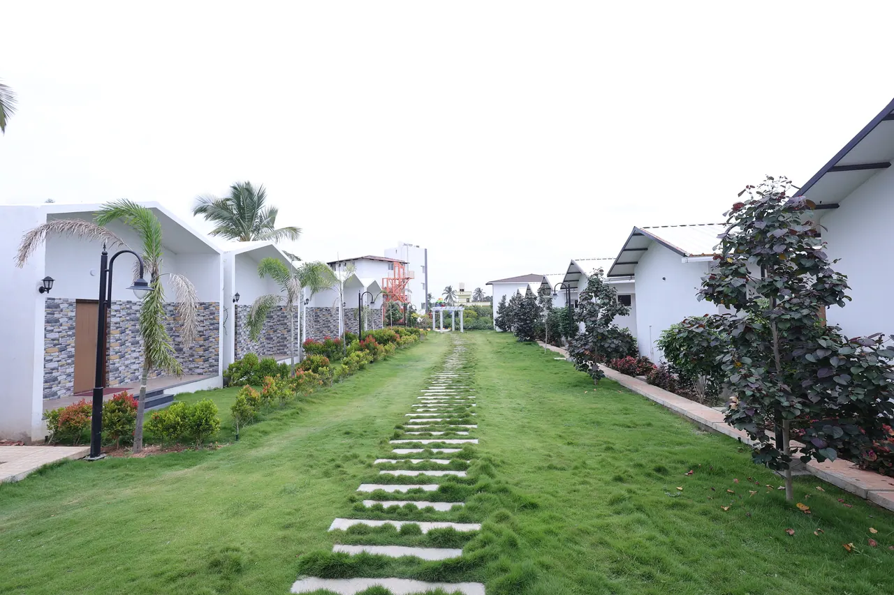 Stepping stones set into grass leading between villas at Sree Raaga Resorts