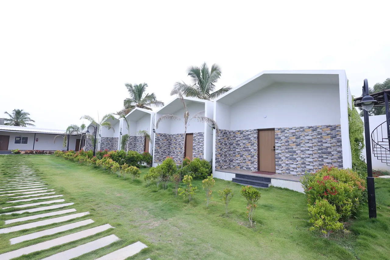 A stepping-stone path set into the lawn running along the row of villas at Sree Raaga Resorts