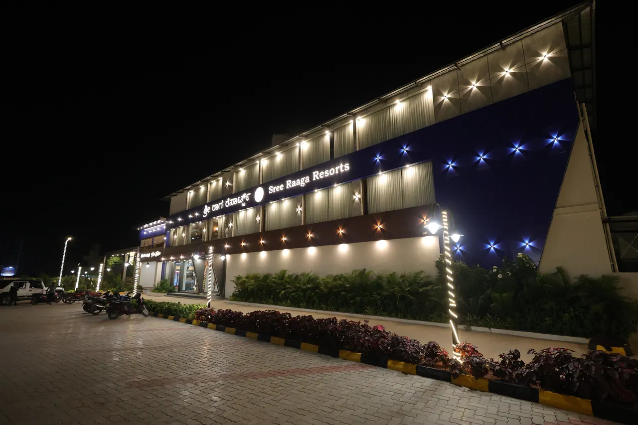The illuminated facade of Sree Raaga Resorts at night