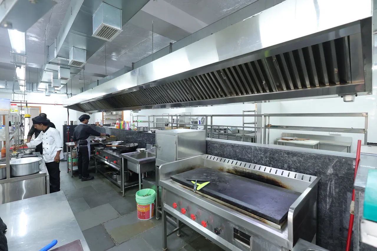 Stainless steel commercial kitchen with extraction hoods