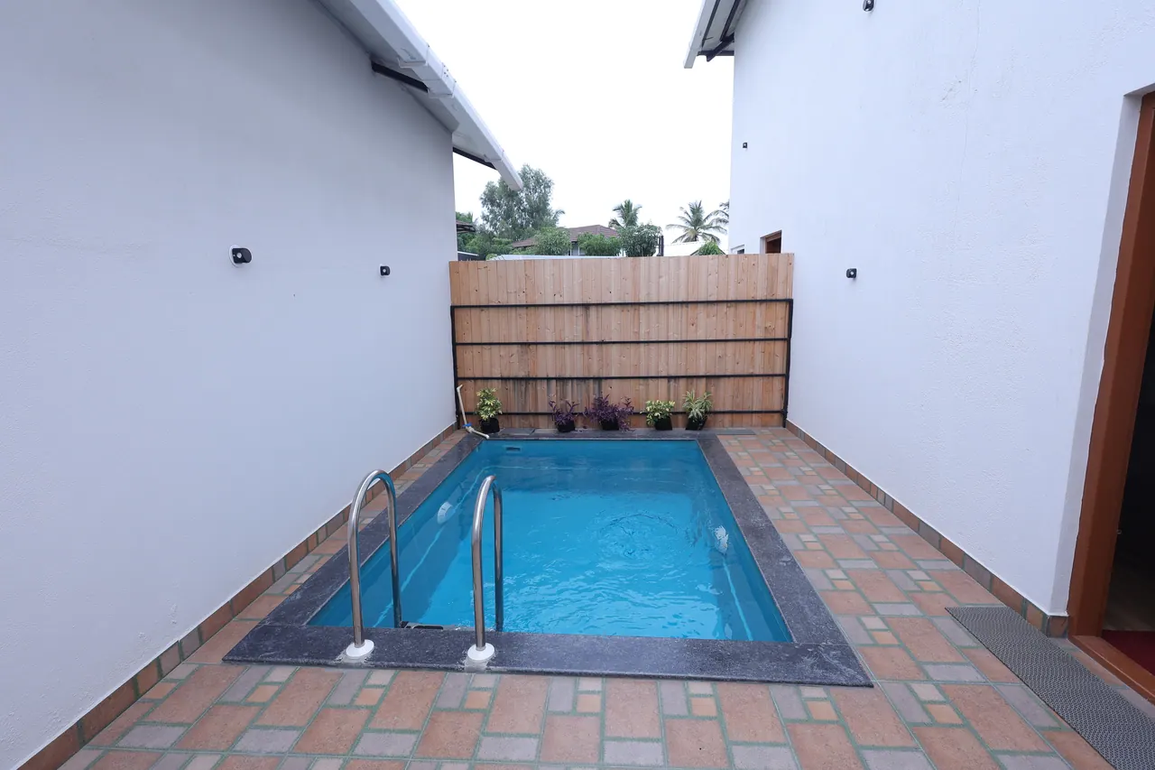 Brick-paved deck and timber privacy screen around the duplex private pool