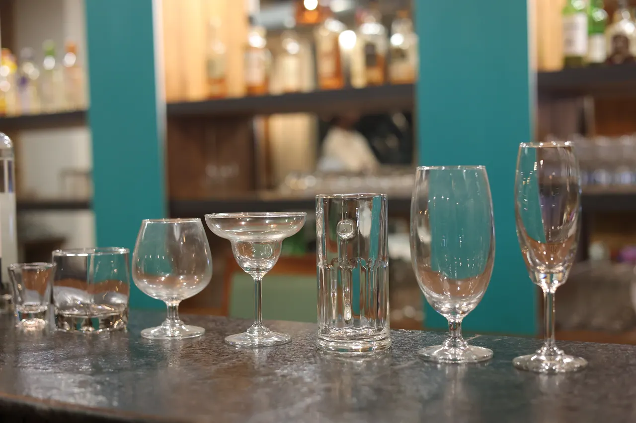 Assorted cocktail and wine glasses lined up on the bar