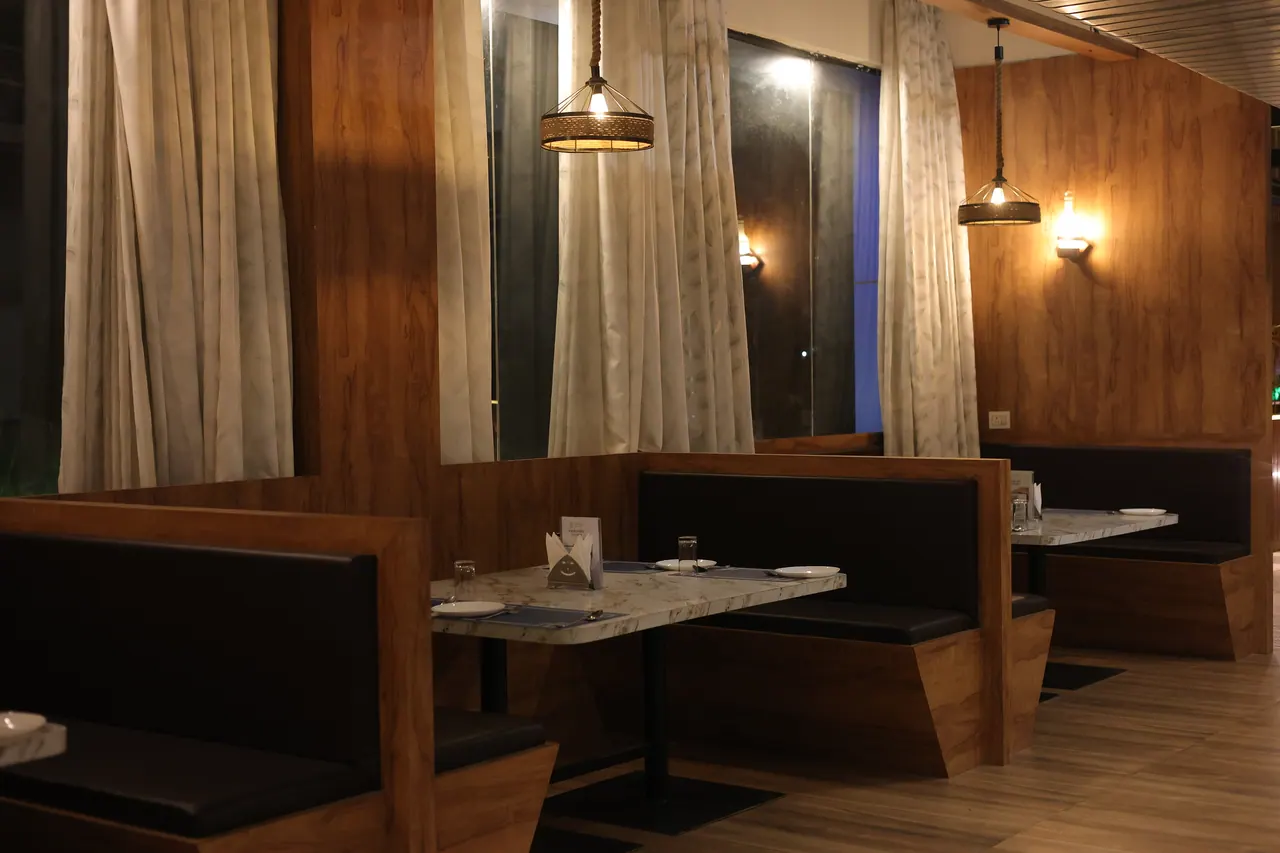 A row of dining booths with marble tables in the Muraaya fine-dine room