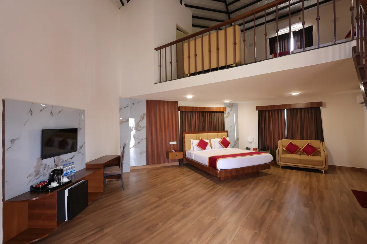 View of the mezzanine level of the duplex showing a second bed behind a wooden balustrade