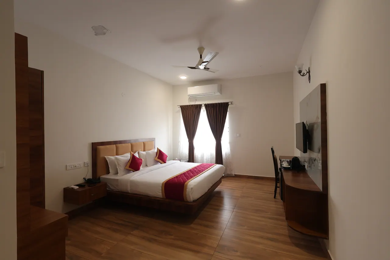 An executive room with a king bed at Sree Raaga Resorts