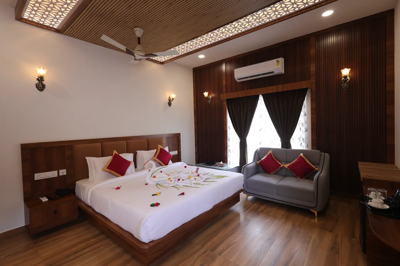 Luxury villa bed dressed with swan towel art and fresh flower petals for a honeymoon stay