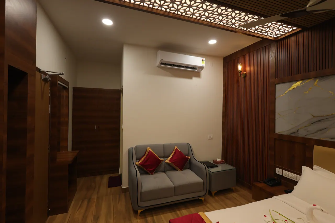 A two-seater sofa and side table in the corner of a luxury villa bedroom